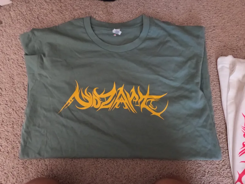Green shirt yellow print Nozart tee